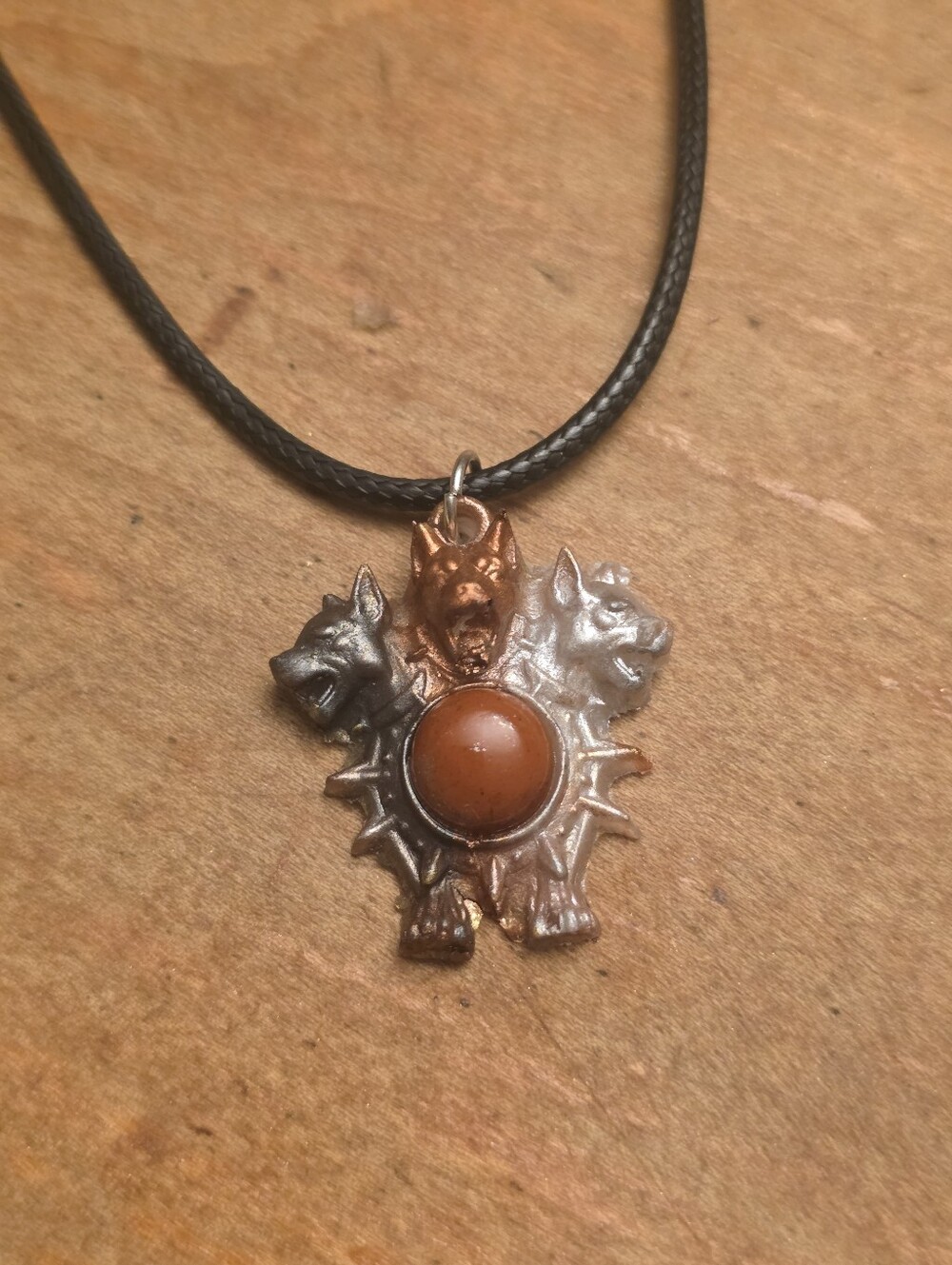 3 Headed Dog With Central Gemstone On A Black Cord Necklace